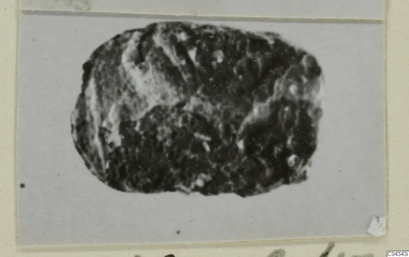 Oval stone seal or gem from Ayia Irini, dark with a rough, worn surface