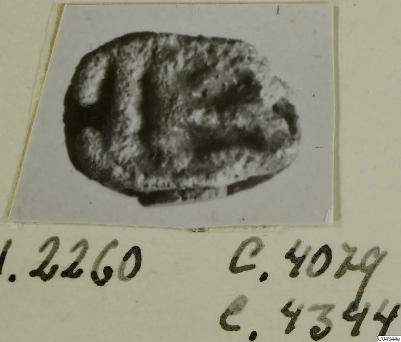 Small oval stone seal with incised markings, photographed on a mount from Ayia Irini