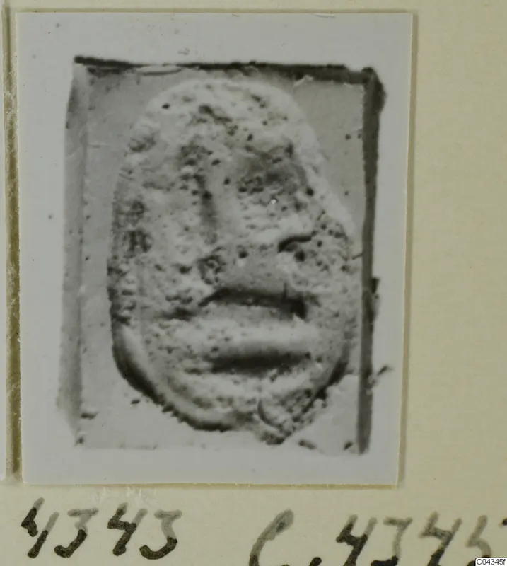 Stone glyptic object with a raised face in relief, from Ayia Irini