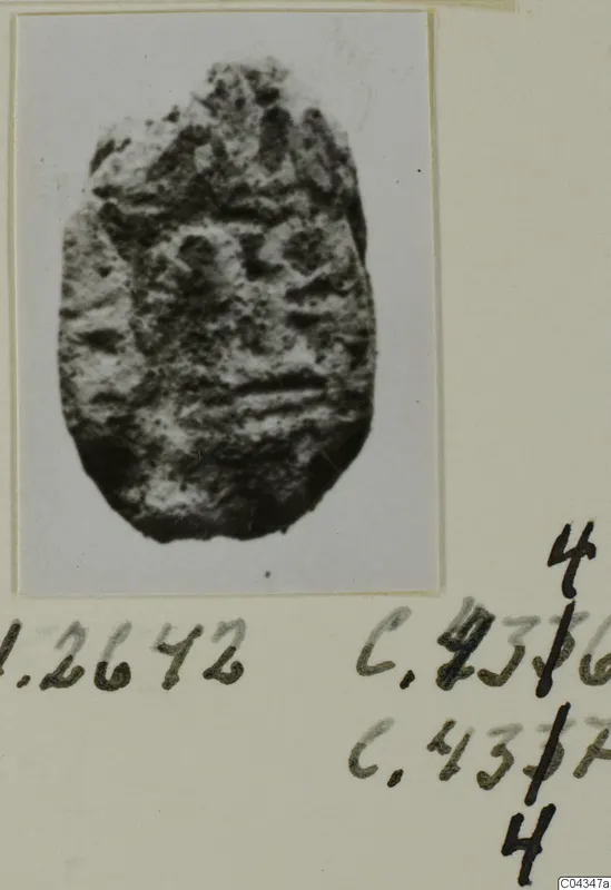 Oval stone seal or gem with a worn, uneven surface and faint raised markings.