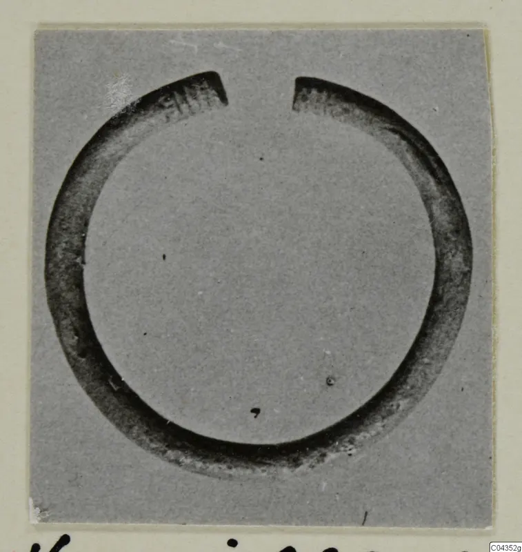 Open silver bracelet from Vouni, shown in close view on a grey card mount