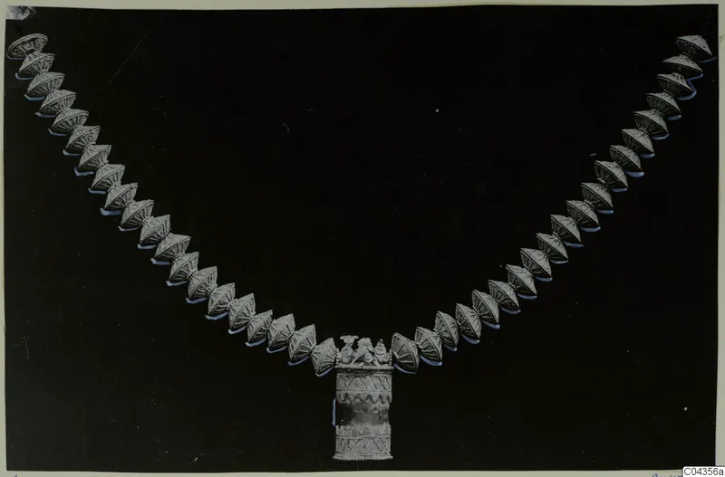Necklace of linked cone-shaped beads with a cylindrical pendant, from Arsos