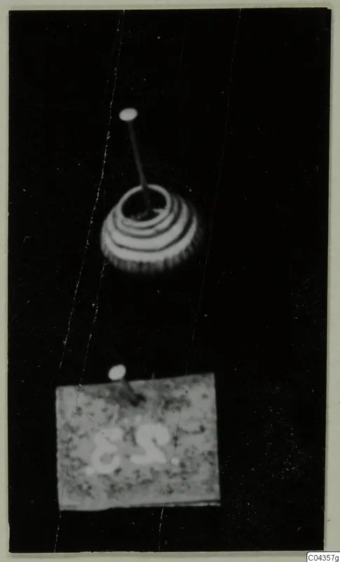 Pins and a banded conical object photographed against a black background, from the Lapithos Kastros tomb finds