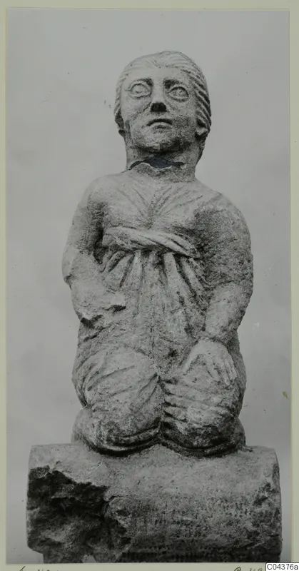Stone statue of a kneeling figure from Soli, shown against a plain grey backdrop
