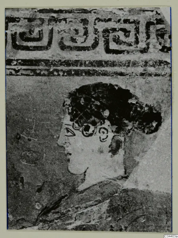Close view of a painted profile head with dark hair, below a band of key pattern, pottery White Grounded Ware