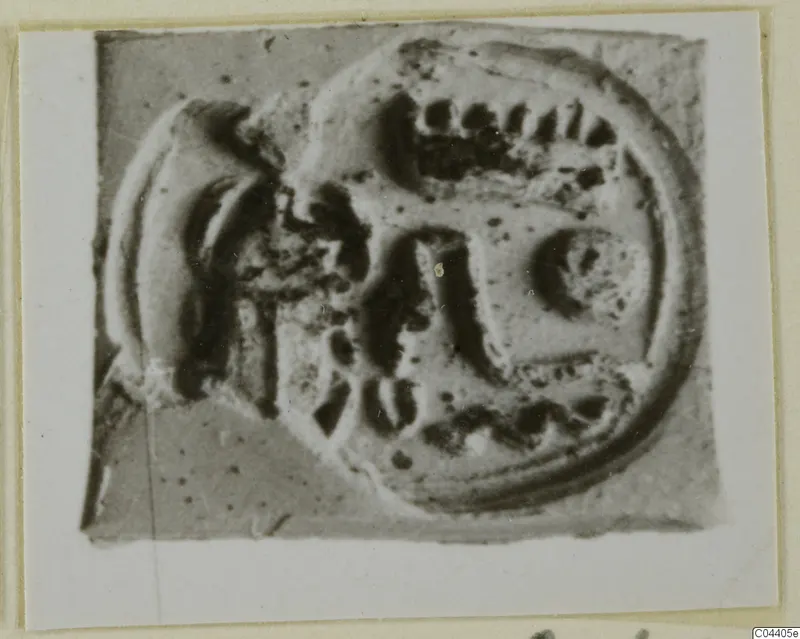 Glyptic: oval stone seal with a carved design, shown in a close photograph on a mounted card