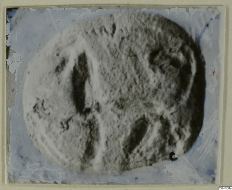 Blurred photograph of an oval engraved seal or gem with dark incised lines
