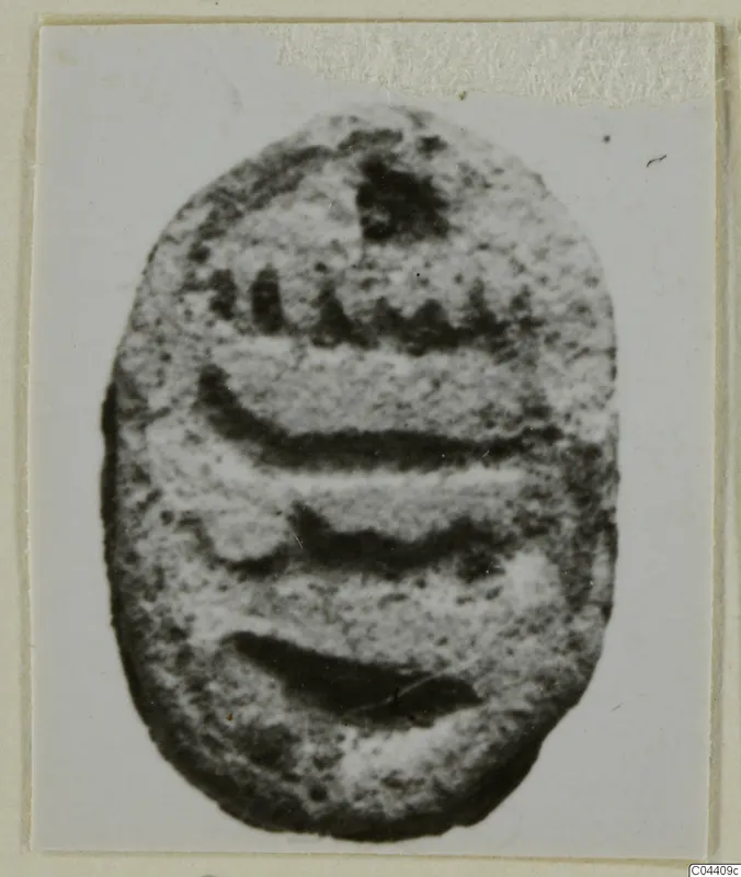 Oval stone seal with carved lines across its flat face, from Ayia Irini