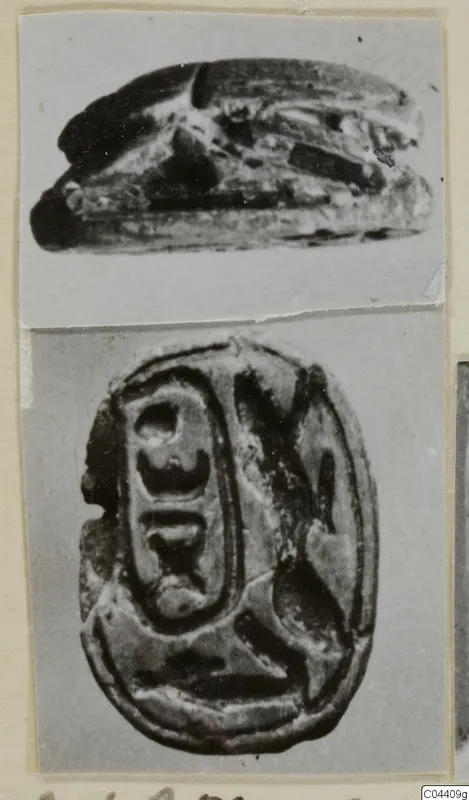 Two photographs of a scarab seal, one showing its side and one its carved base with incised signs, mounted on a card