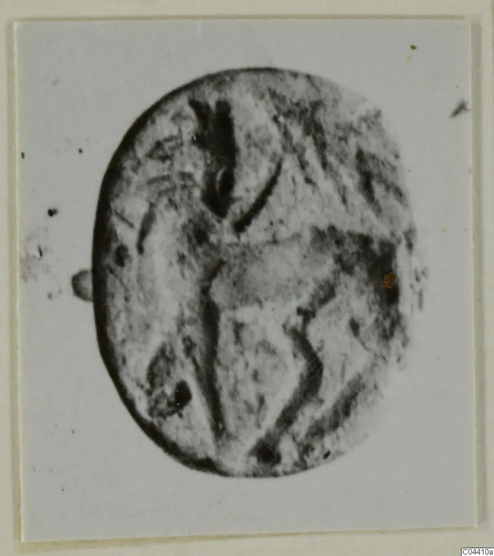 Engraved oval seal or gem in stone, from Ayia Irini, shown on a pale card mount