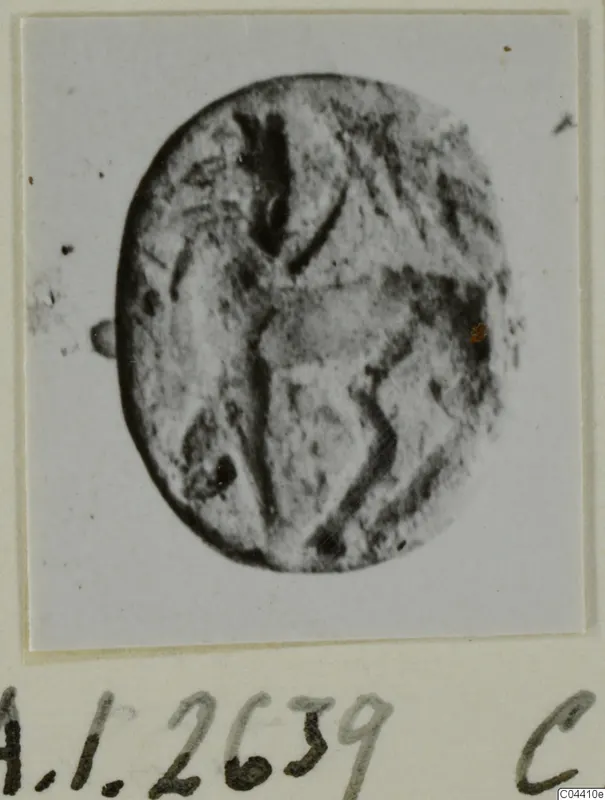 Oval seal or gem with a faint engraved design, shown face-on.