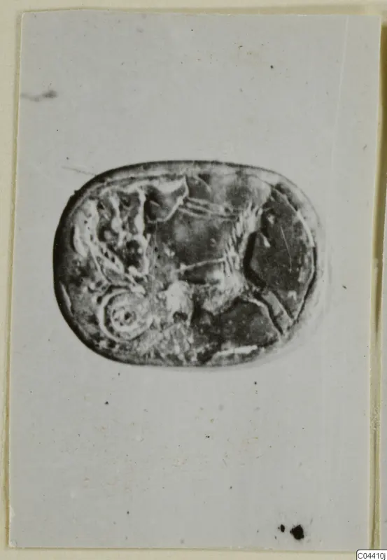 Engraved stone seal or gem from Ayia Irini, photographed on a pale card.