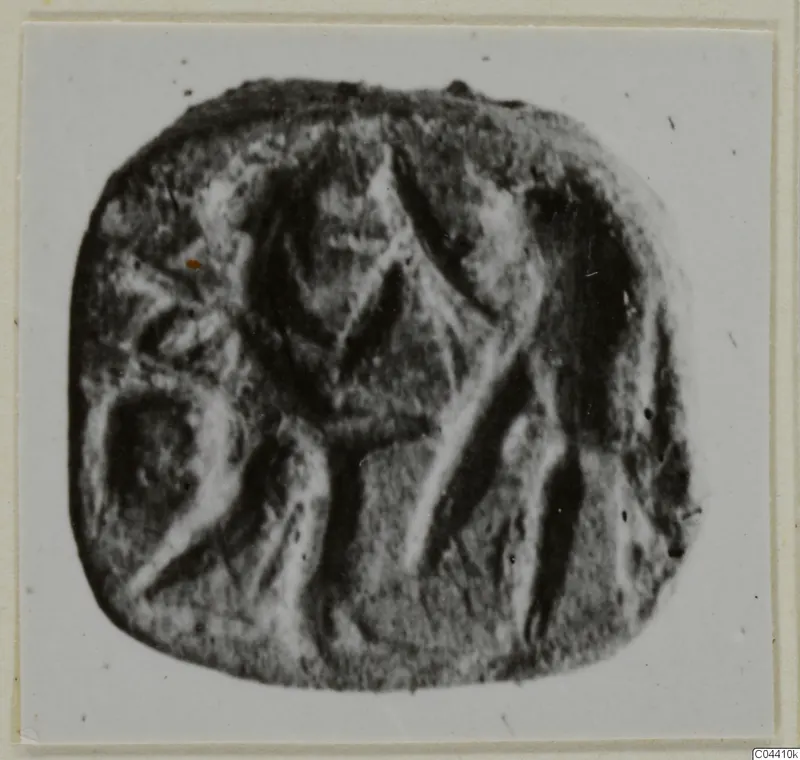 Engraved stone seal from Ayia Irini with a central figure-like design, shown on a light card mount