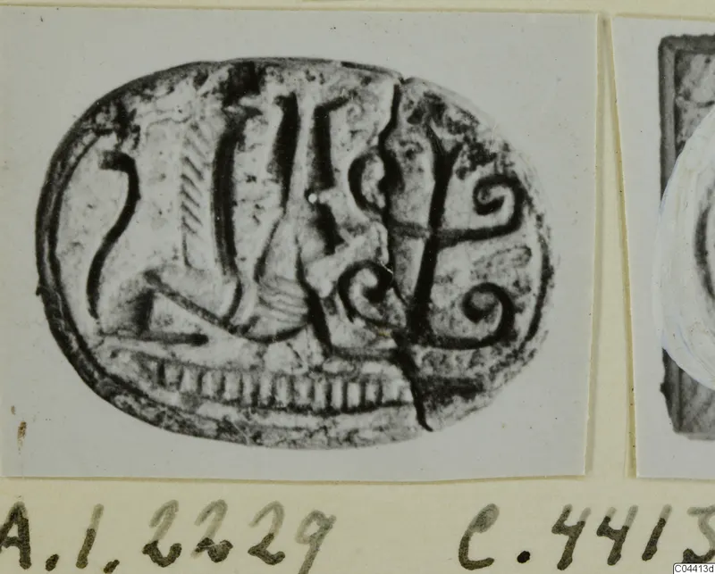 Oval engraved seal with a figure, vertical strokes and two spirals, photographed on a card mount