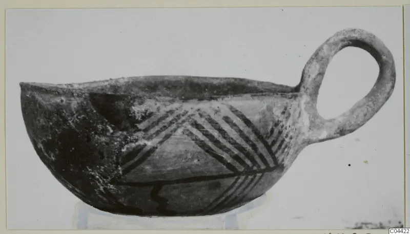 Pottery White Painted III-2 bowl from Lapithos, with one loop handle and dark painted bands in a chevron pattern