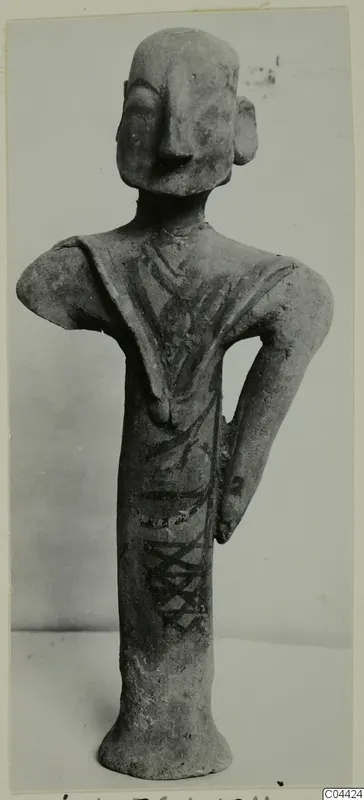 Terracotta figurine of a standing figure with one hand on the hip and dark painted bands, from Ayia Irini