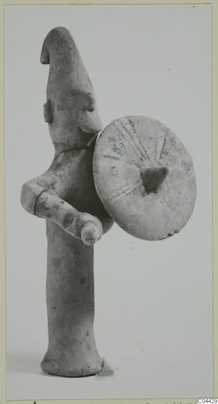 Terracotta figurine of a standing figure holding a round shield, Ayia Irini