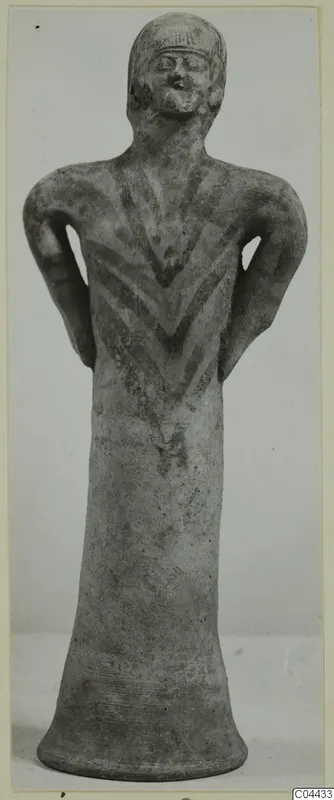 Terracotta figurine of a standing figure with arms bent at the waist and a dark painted chevron pattern on the chest