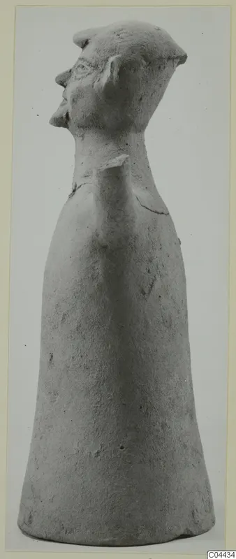 Terracotta figurine with a bell-shaped body and a head in profile facing left