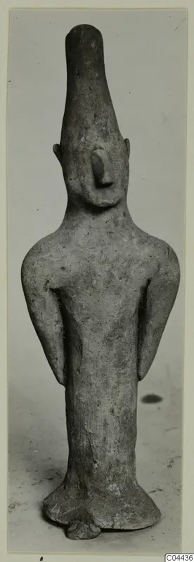 Terracotta figurine from Ayia Irini of a standing figure with a tall head and arms held at its sides