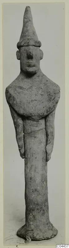 Terracotta figurine of a standing figure with a tall conical headdress and arms held close to the body