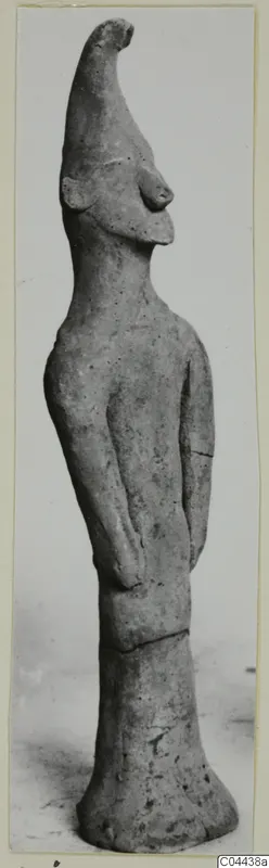Terracotta figurine of a standing figure from Ayia Irini, with a tall pointed head and arms held at the sides