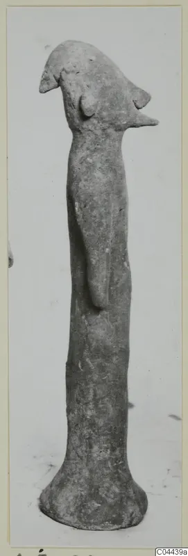 Terracotta figurine with a beak-like head on a tall, slender body, from Ayia Irini