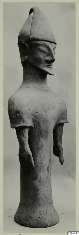 Terracotta figure of a standing human figure with a tall pointed cap and flared base, from Ayia Irini