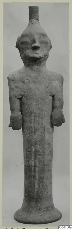 Terracotta figure of a standing human with arms at the sides and a tall flared base, from Ayia Irini