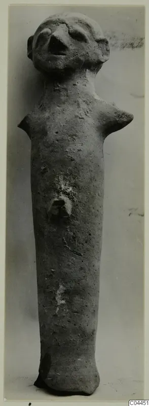 Terracotta figurine of a standing human figure with a pinched face, stub arms and a small knob at the middle of the body