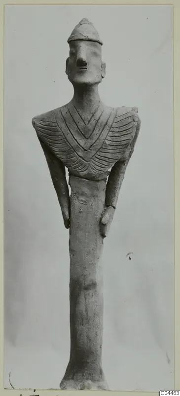 Terracotta figurine of a standing figure with a cap-like head and an incised chevron pattern across the chest