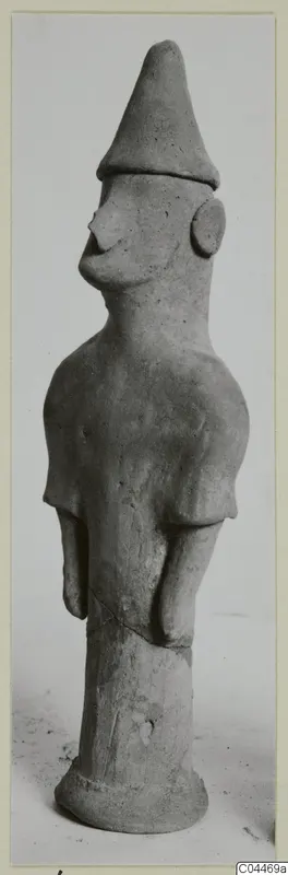 Terracotta figurine of a standing human figure with a tall conical head covering, from Ayia Irini