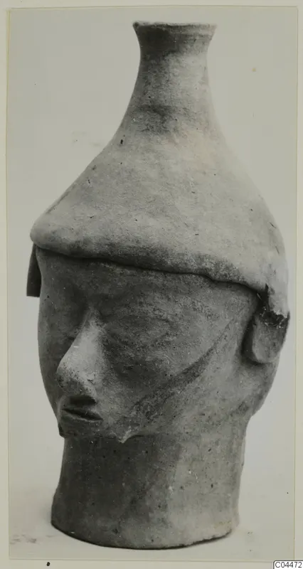 Terracotta vessel in the form of a human head with a tall flared neck, from Ayia Irini