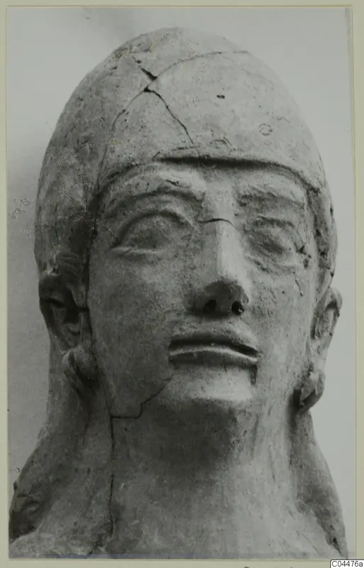 Terracotta Neo-Cypriote head, front view, with cracks across the crown and cheek