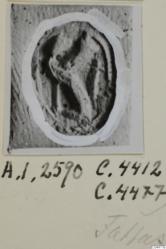 Oval seal or gem with an incised design, shown as a print on a photo card with handwritten notes