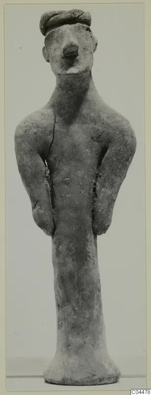 Terracotta standing figurine with a rolled cap or headband, arms held at the sides and a flared base.