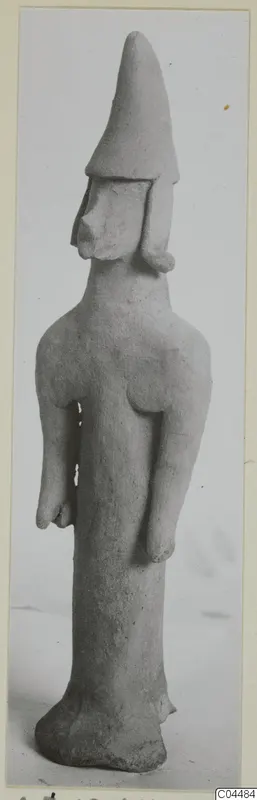 Terracotta figurine of a standing figure with a tall conical head covering, from Ayia Irini