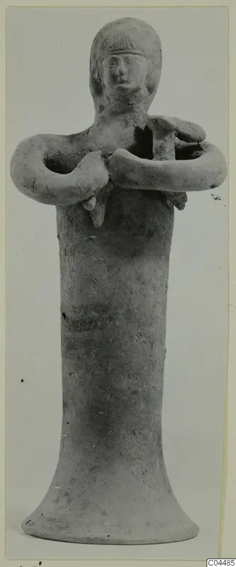Terracotta figurine of a standing figure with arms folded across the chest, from Ayia Irini
