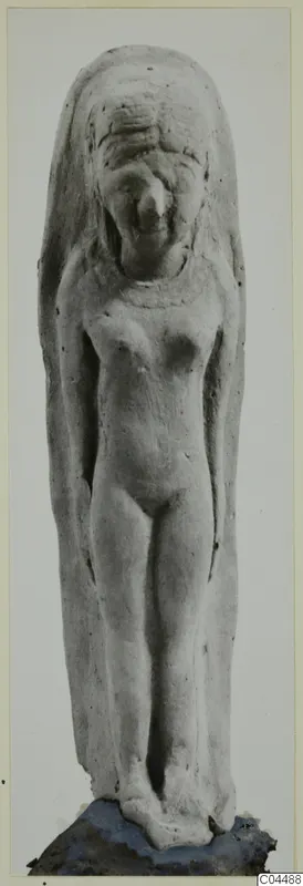Terracotta figurine of a standing nude figure from Ayia Irini, arms at its sides, with a long veil or mantle down both sides.