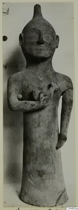 Terracotta standing figure with one arm across the chest holding a small animal-like form, the other arm hanging at the side