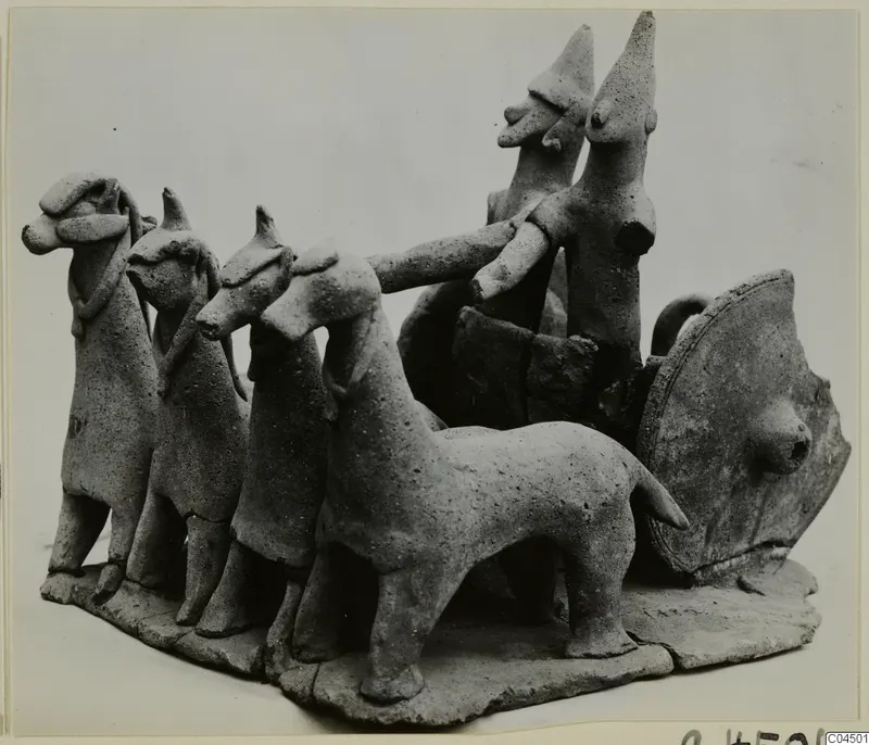 Terracotta model of a two-wheeled vehicle drawn by four animals, with two standing figures in the cart