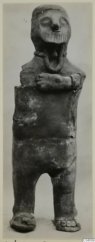 Terracotta figurine of a standing human figure with arms folded across the chest