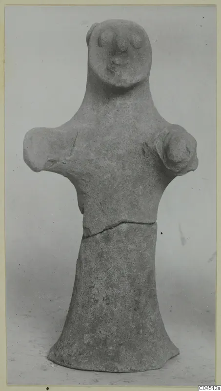 Terracotta figurine from Ayia Irini with a rounded head, stub arms and a flared base