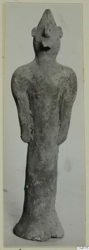 Terracotta standing figurine with a pointed head-top and flared base, from Ayia Irini