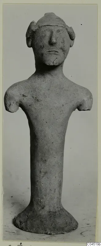 Terracotta figurine of a standing human figure with a cylindrical body and broken-off arms, from Ayia Irini