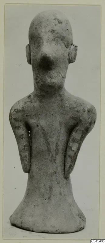 Terracotta figurine of a standing human figure with a large nose and arms held close to the sides, from Ayia Irini.