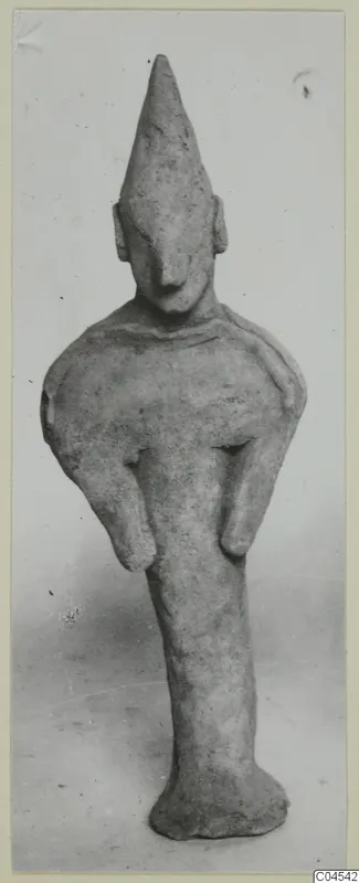 Terracotta figurine of a standing figure with a tall pointed head and bent arms