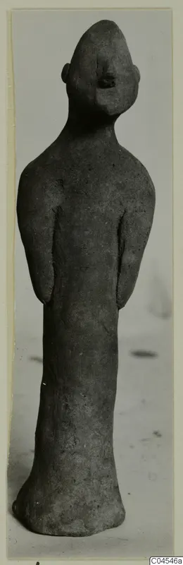 Terracotta figurine of a standing human figure with arms held close to the body, from Ayia Irini.