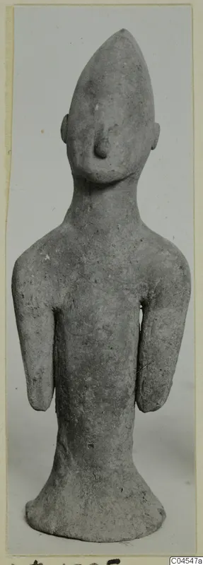 Terracotta figurine of a standing figure with a pointed head and arms at its sides, from Ayia Irini