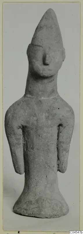 Terracotta standing figurine with a tall pointed head and short arms, from Ayia Irini
